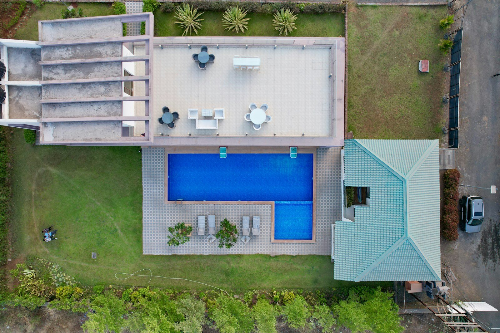 Illustrative aerial photograph of a villa with a pool and landscaped garden; not an advertised project